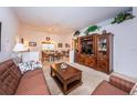 Spacious living room with wood furniture and view into dining area at 4136 Rhone Dr, New Port Richey, FL 34655