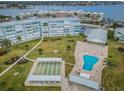 Overhead view of pool and shuffleboard amenities amidst landscaping at 1868 Shore S Dr # 410, South Pasadena, FL 33707