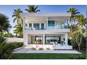 Stunning two-story modern home with a glass balcony and a beautiful outdoor seating area at 1002 W Charter St, Tampa, FL 33602