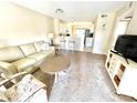 Bright living room with light colored couch and view of kitchen at 4529 Whitton Way # 223, New Port Richey, FL 34653