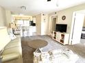 Bright living room with light colored couch and view of kitchen at 4529 Whitton Way # 223, New Port Richey, FL 34653