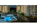 Community pool and surrounding area at night at 1200 Country Club Dr # 2106, Largo, FL 33771