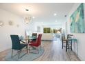 Bright dining area with glass table and modern light fixture at 1750 Belleair Forest Dr # C17, Belleair, FL 33756
