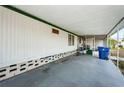 Covered patio with concrete flooring and storage at 137 New England Ave # 20, Palm Harbor, FL 34684