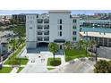 Modern building exterior with landscaping and parking at 211 Dolphin Pt # 303, Clearwater, FL 33767