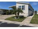 Single-wide manufactured home with carport and landscaping at 13225 101St St # 482, Largo, FL 33773