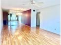 A spacious living room features mirrored wall, wood floors, and a ceiling fan at 2256 Philippine Dr # 46, Clearwater, FL 33763