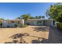 Ranch style home with light blue exterior and gravel driveway at 236 45Th Ave, St Pete Beach, FL 33706