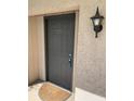 Condo building exterior door entrance with a light fixture at 8693 Bardmoor Blvd # 207B, Seminole, FL 33777