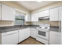 Simple kitchen with white cabinets and granite countertops at 101 Lake Ne Ave # 225, Largo, FL 33771