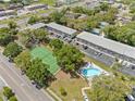 An aerial view of an apartment complex with a pool and tennis court at 101 Lake Ne Ave # 225, Largo, FL 33771
