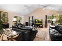 Relaxing living room with black leather couches and high ceilings at 3610 11Th N Ave, St Petersburg, FL 33713