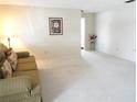 Spacious living room with carpeted floor and neutral decor at 9155 42Nd N St # 5, Pinellas Park, FL 33782