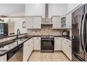 Modern kitchen with stainless steel appliances and granite countertops at 1729 Oakwood Estates Dr, Plant City, FL 33563
