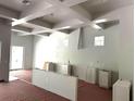 Bright kitchen featuring a coffered ceiling, white cabinets, and stainless steel appliances ready for installation at 8418 Fussell Dr, Wesley Chapel, FL 33545