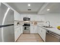 Modern kitchen featuring stainless steel appliances and white shaker cabinets at 12125 Spartan Way # 201, Hudson, FL 34667