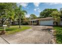 Single-story house with attached garage and well-maintained landscaping at 2045 Golf View Dr, Dunedin, FL 34698