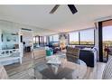 Bright living area with a modern dining table set, comfortable seating, and sliding glass doors to a balcony at 6219 Palma Del Mar S Blvd # 602, St Petersburg, FL 33715