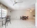 Simple dining area with tile floors and ceiling fan at 650 Pinellas Point S Dr # 231, St Petersburg, FL 33705