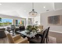 Spacious dining area with a large chandelier and access to living room and kitchen at 47A Bayview S Ct, St Petersburg, FL 33711