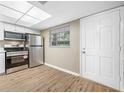 Updated kitchen with stainless steel appliances and light wood flooring at 821 Deleon Ct # 103, Dunedin, FL 34698