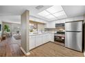 Modern white kitchen with stainless steel appliances at 821 Deleon Ct # 103, Dunedin, FL 34698