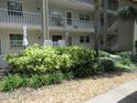 Building exterior with landscaping and walkway at 940 Virginia St # 107, Dunedin, FL 34698