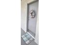 Condo entry with a welcoming seashell wreath and mat at 2625 State Road 590 # 1523, Clearwater, FL 33759