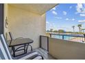 Condo balcony with table and chairs overlooking the pool and ocean at 6009 Sea Ranch Dr # 107E, Hudson, FL 34667