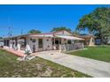 Charming one-story home with a covered porch and well-manicured lawn at 247 93Rd N Ave, St Petersburg, FL 33702