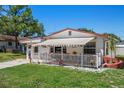 Quaint one-story home with a covered patio and a landscaped yard at 247 93Rd N Ave, St Petersburg, FL 33702