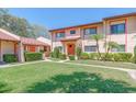 Inviting condo with well-kept lawn, colorful flowers, green shrubbery, and lush palm trees at 9543 86Th Ave # 9543, Seminole, FL 33777