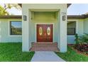 Elegant double front doors with glass accents leading into the home at 756 Bowman Ter, Port Charlotte, FL 33953