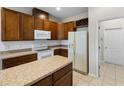 Kitchen with wood cabinets and island at 2622 Yukon Cliff Dr, Ruskin, FL 33570