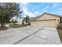 Two-car garage and front yard at 2622 Yukon Cliff Dr, Ruskin, FL 33570