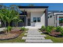 Modern home with gray and white exterior, landscaping, and walkway at 4511 24Th S Ave, St Petersburg, FL 33711