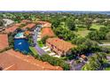 Beautiful aerial view of a well-maintained neighborhood featuring lush landscaping, a community pool, and a scenic water feature at 6251 Vista Verde W Dr, St Petersburg, FL 33707