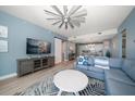 Spacious living room with large TV and sectional sofa at 300 150Th Ave # 411, Madeira Beach, FL 33708