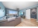 Open living room with water views, large sectional sofa, and sliding doors at 300 150Th Ave # 411, Madeira Beach, FL 33708
