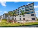 Modern building exterior with pool and palm trees at 300 150Th Ave # 411, Madeira Beach, FL 33708