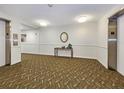 Hallway with carpet, elevator access, and a small table at 851 Bayway Blvd # 205, Clearwater Beach, FL 33767