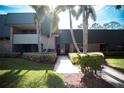 Building exterior with landscaping and walkway at 36750 Us 19 # 2052, Palm Harbor, FL 34684