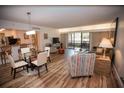 Open living and dining area with wood-look floors at 36750 Us 19 # 2052, Palm Harbor, FL 34684
