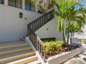 The entrance to the building features stairs, a small garden, and the unit number at 1801 Mariner Dr # 20, Tarpon Springs, FL 34689