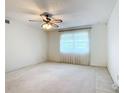 Bright bedroom with ceiling fan and window at 8174 Terrace Garden N Dr # 207, St Petersburg, FL 33709