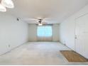 Spacious living room featuring a ceiling fan and large window at 8174 Terrace Garden N Dr # 207, St Petersburg, FL 33709