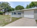 Ranch home with a long driveway and attached garage at 3505 75Th N St, St Petersburg, FL 33710