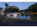 Community pool with lounge chairs and a surrounding fence at 101 Lake Ne Ave # 222, Largo, FL 33771