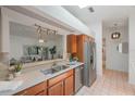 Bright kitchen with stainless steel appliances and wood cabinets at 842 Amelia Ne Ct, St Petersburg, FL 33702