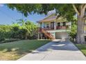 Inviting two-story home with a large front yard, elevated porch and garage at 395 Ulelah Ave, Palm Harbor, FL 34683